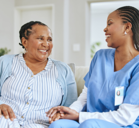 caregiver and senior laughing