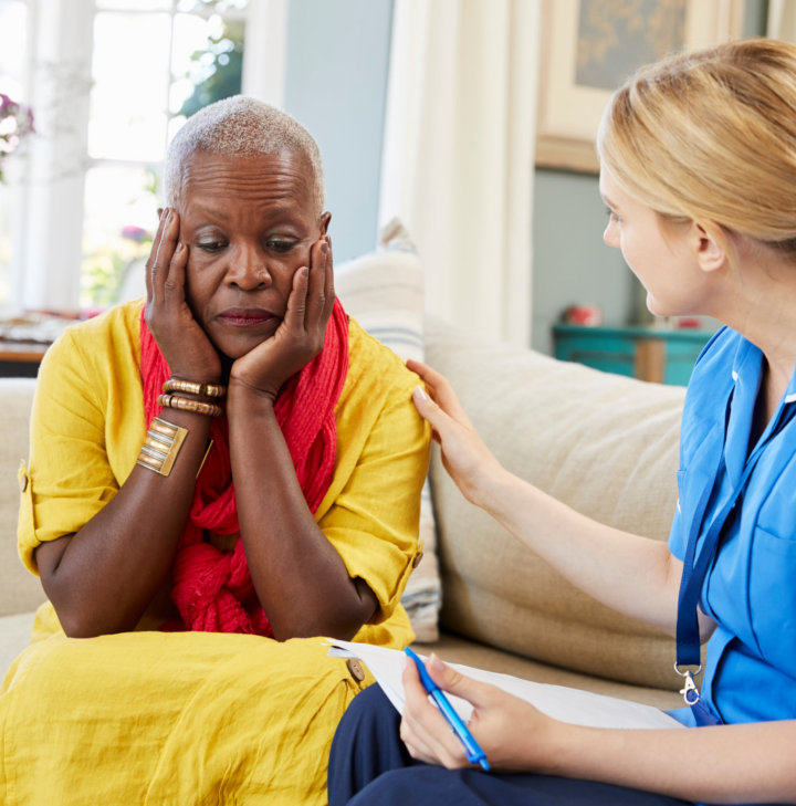 senior comforted by caregiver