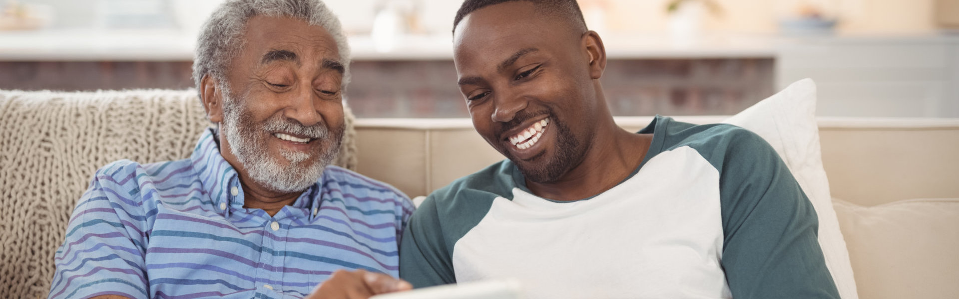 senior laughing with young man