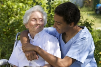 caregiver hugging senior