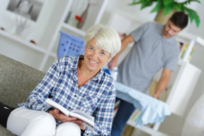 man ironing clothes and senior smiling