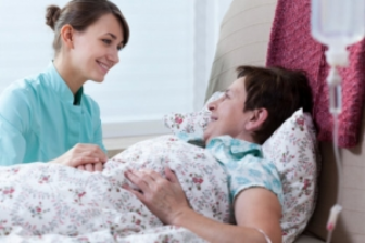 caregiver with senior on bed