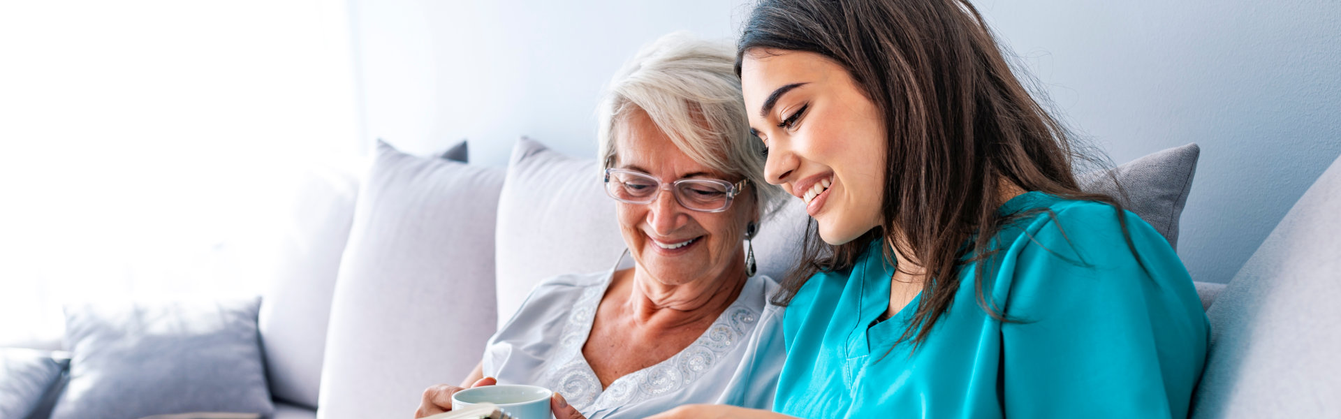 caregiver with senior on bed