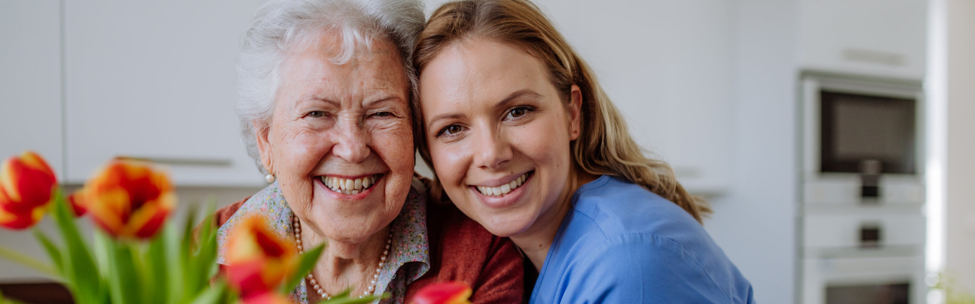 caregiver with senior with flowers