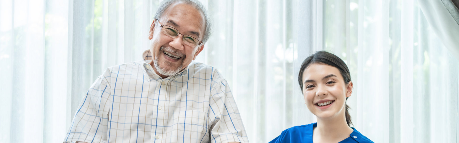 senior with caregiver smiling